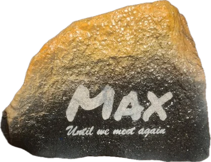 A stone shaded from gold to black with Max and Until we meet again in white lettering.